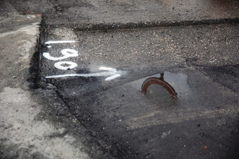 Verkeersbord bij wegwerkzaamheden. Reflectie van een bord gezien in een plas water.